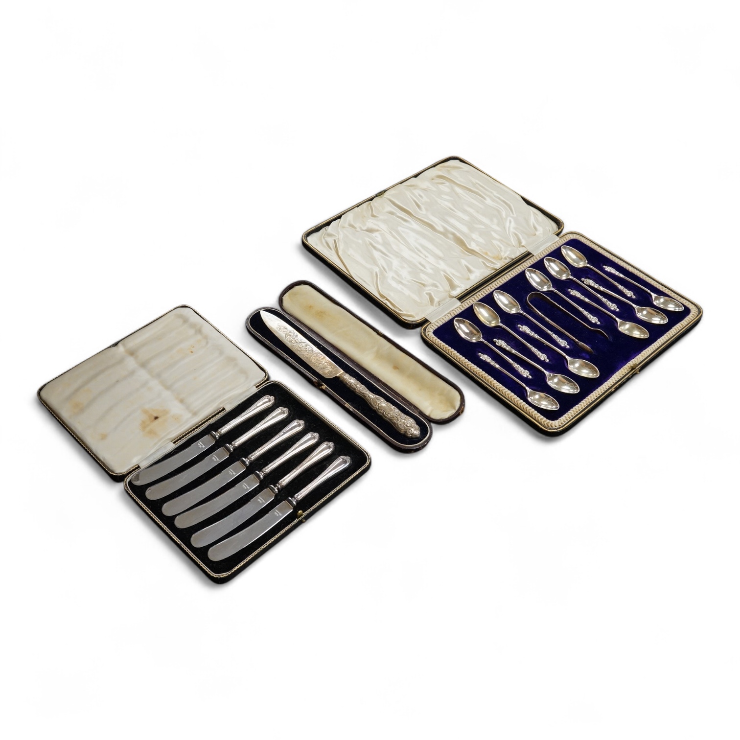 A cased set of twelve Edwardian silver apostle teaspoons with a pair of sugar tongs, Cooper Brothers & Sons, Sheffield, together with a cased Victorian silver bread knife and a cased set of six silver handled steel tea k